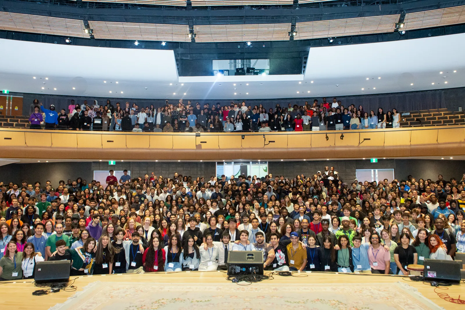 A large group of youth and volunteers gathered together at a conference