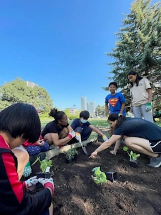 Junior youth planting a garden together as a service project